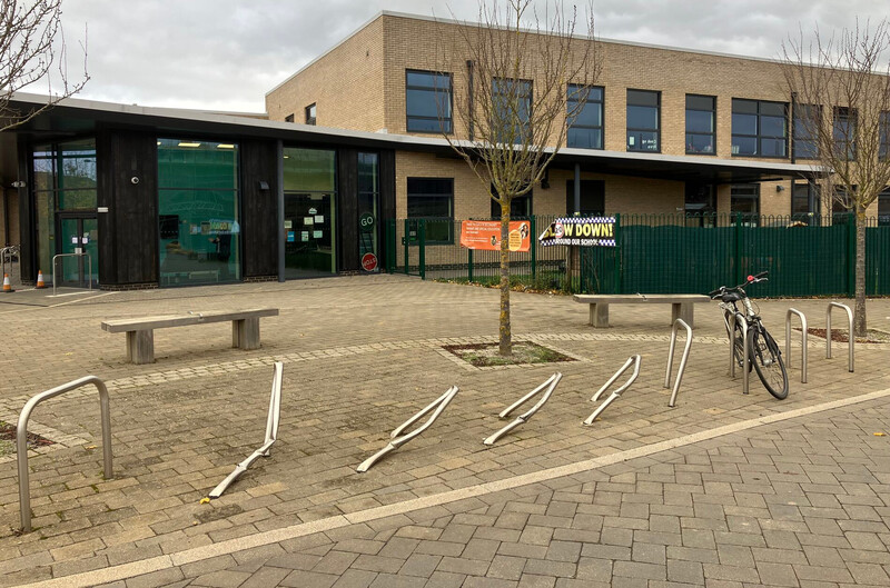 Sheffield cycle parking stands outside Barton Park Primary School, four of them bent over after being hit by a car